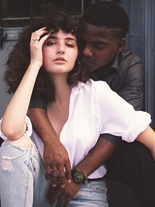 Portrait of Young Man Embracing His Girlfriend from behind photo