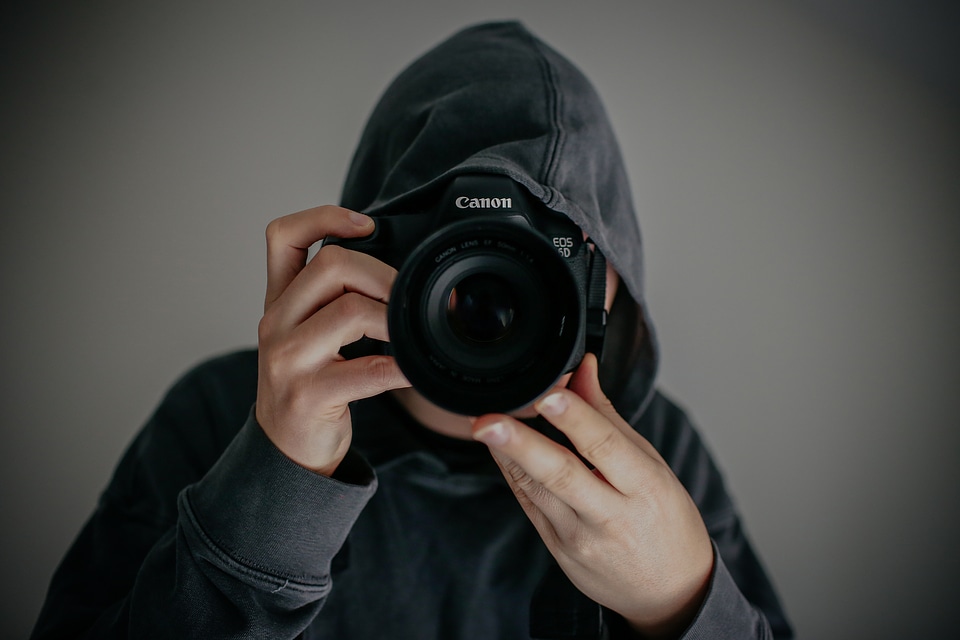 Guy in the Hood with Canon DSLR Camera