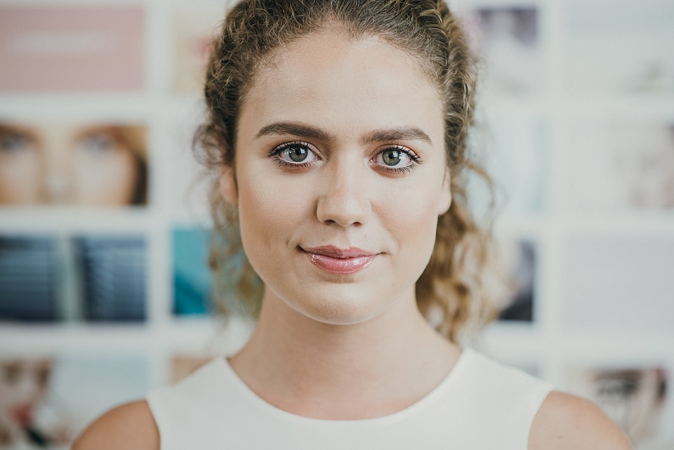 Portrait of Woman with Curly Hair Looking at a Camera