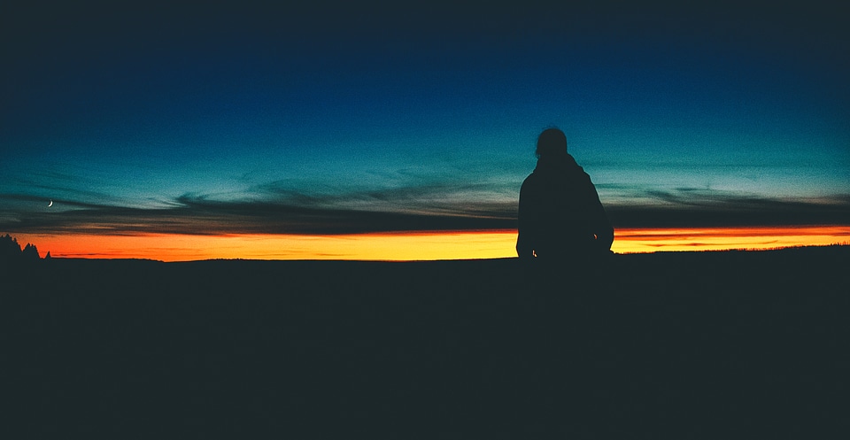 Silhouette of Lonely Person at Sunset photo