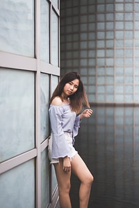 Asian Woman Posing Leaning against the Wall photo