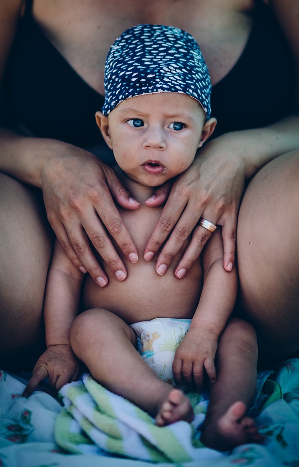 Cute Little Baby Boy and His Mother Sitting