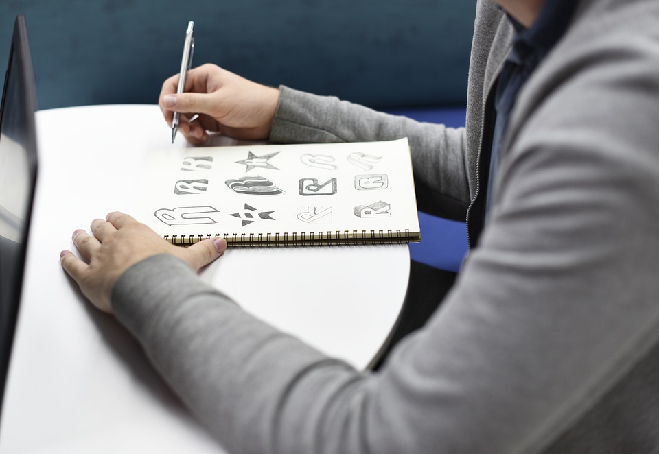 Designer Sketching in His Notebook photo