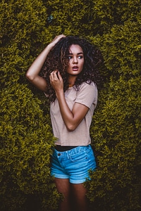 Portrait of Pretty Woman with Long Curly Hair Outdoors photo