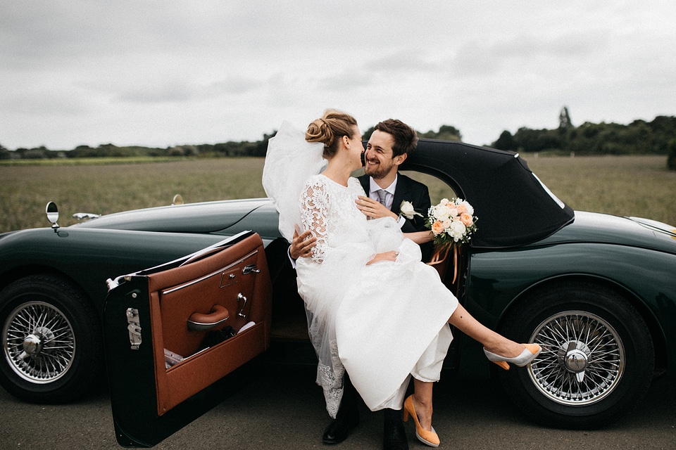 Just Married Couple Together in Black Vintage Car