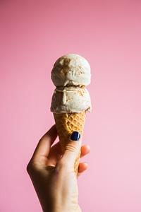Female Hand Holding Ice Cream in Waffle Cone photo