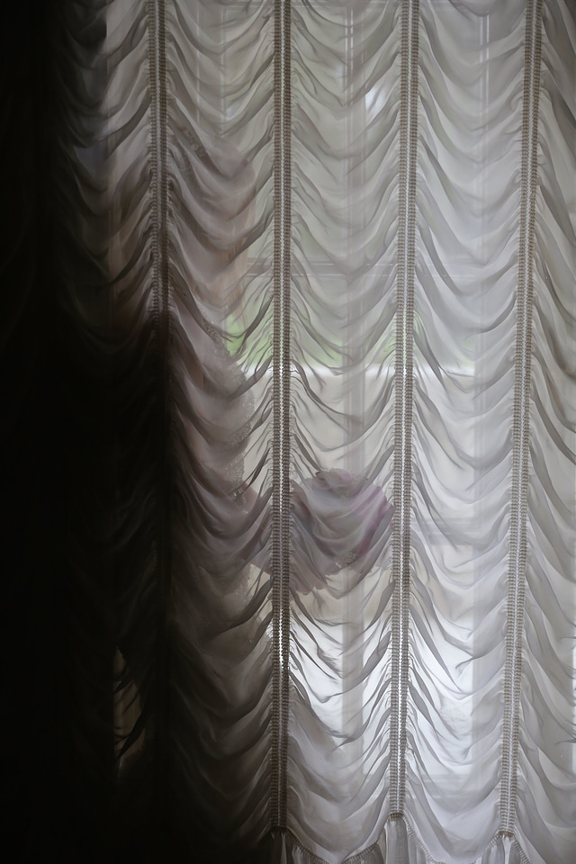 Woman curtain window