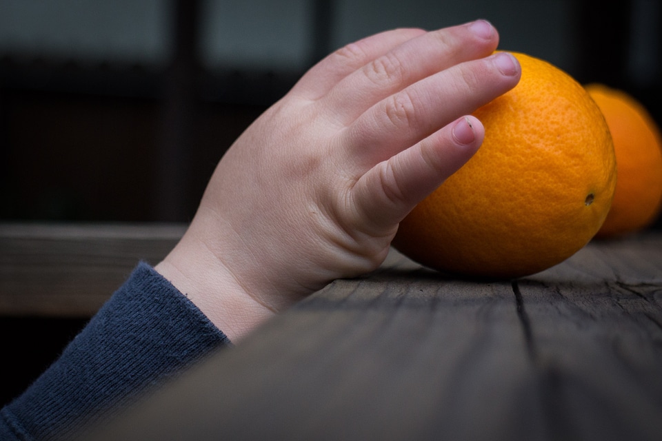 Orange child reaching
