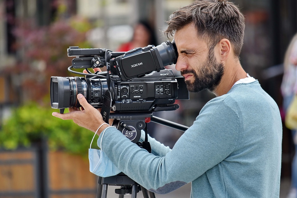 Handsome man filming photo