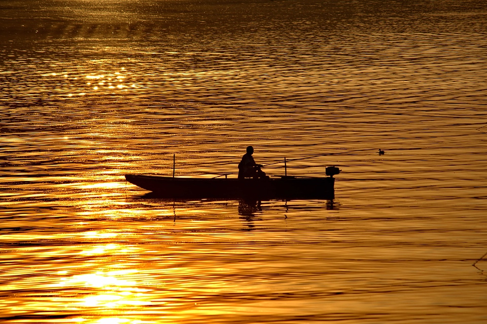 Boat fisherman golden glow photo