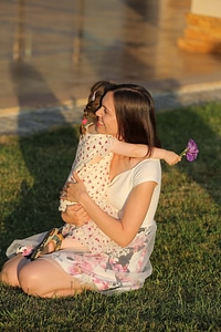 Daughter hugging mother photo