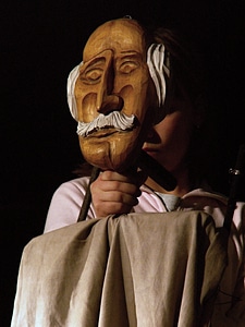 Old man puppeteers theater