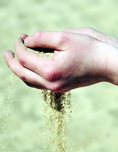 Hands man sand photo
