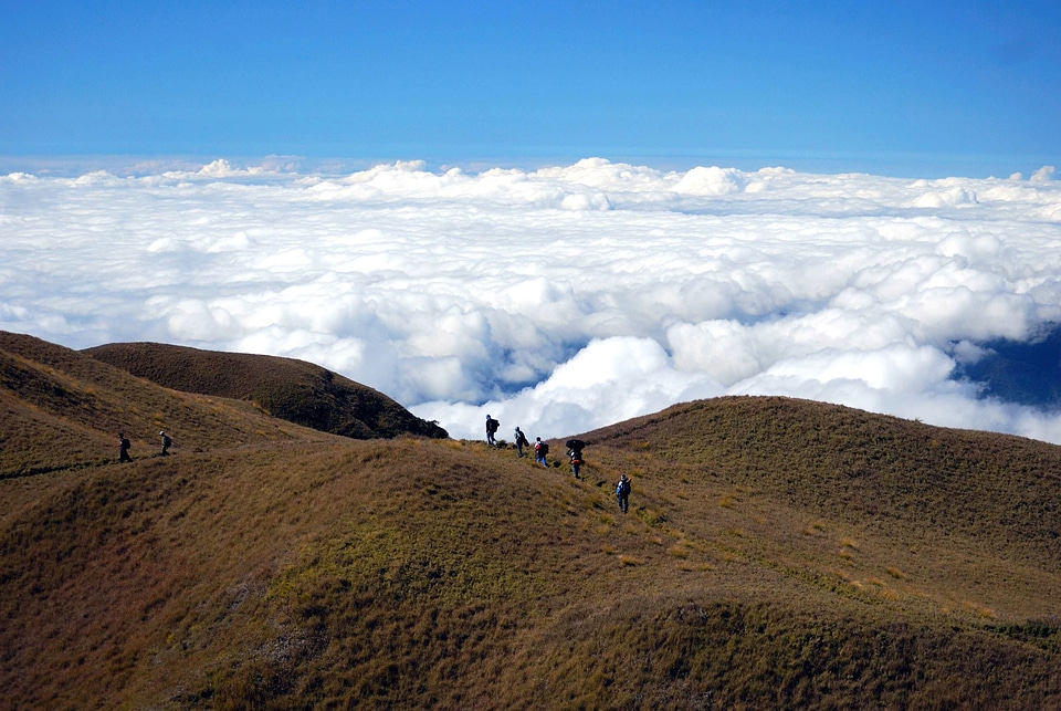 Clouds hiking hillside