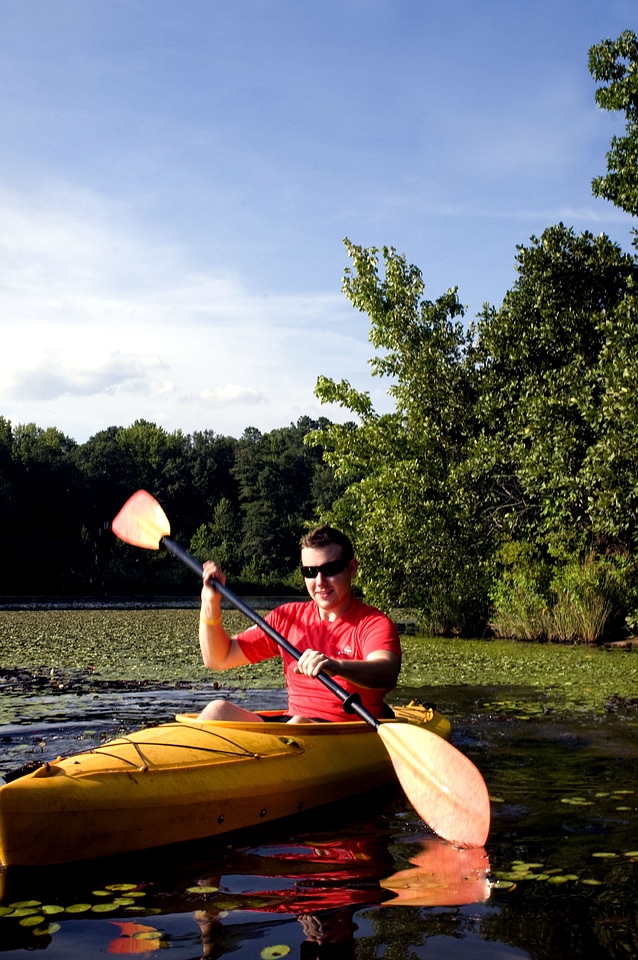 Husband kayaking lake