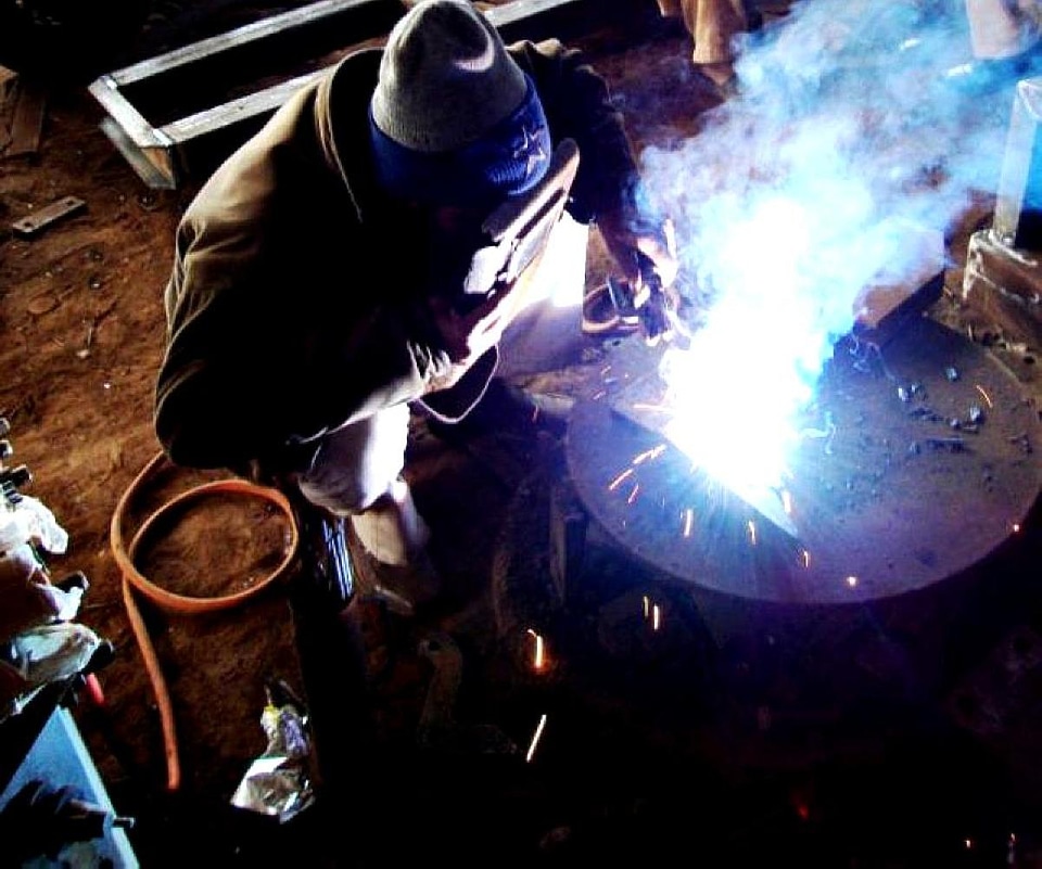 Business construction worker welding