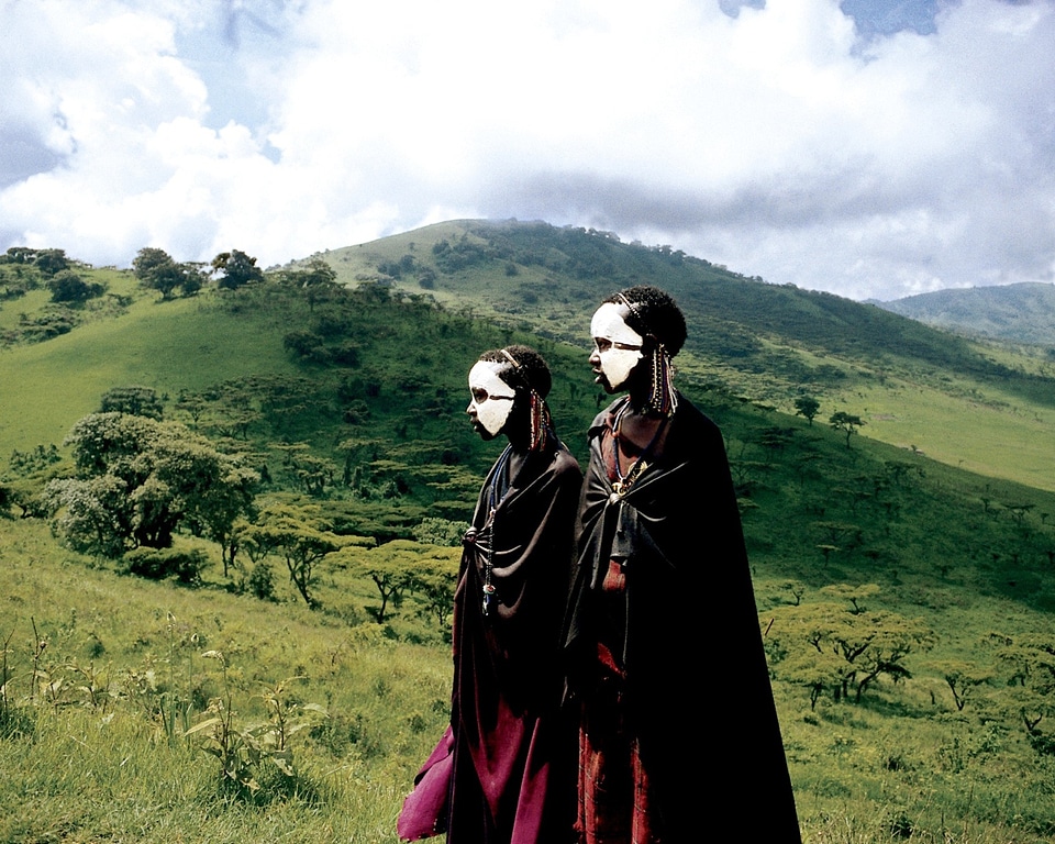 Painted faces mountains sky