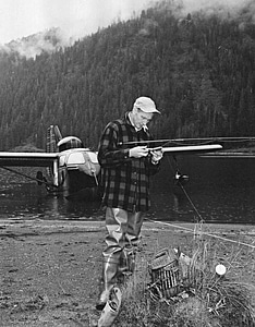 Angler fly fishing lake