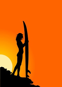Surfer in silhouette holding long surf boards at sunset photo
