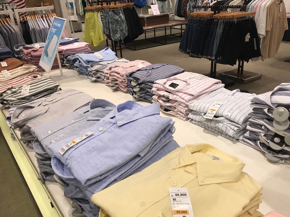 Various color shirts at shelf in shop