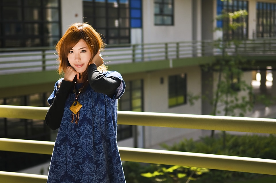 A Beautiful Japanese Girl Posing Against A Railing