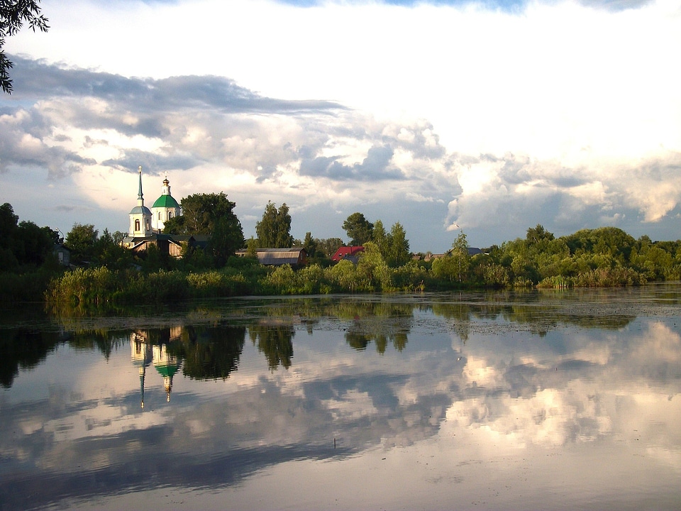 church reflecting in the water with sky photo