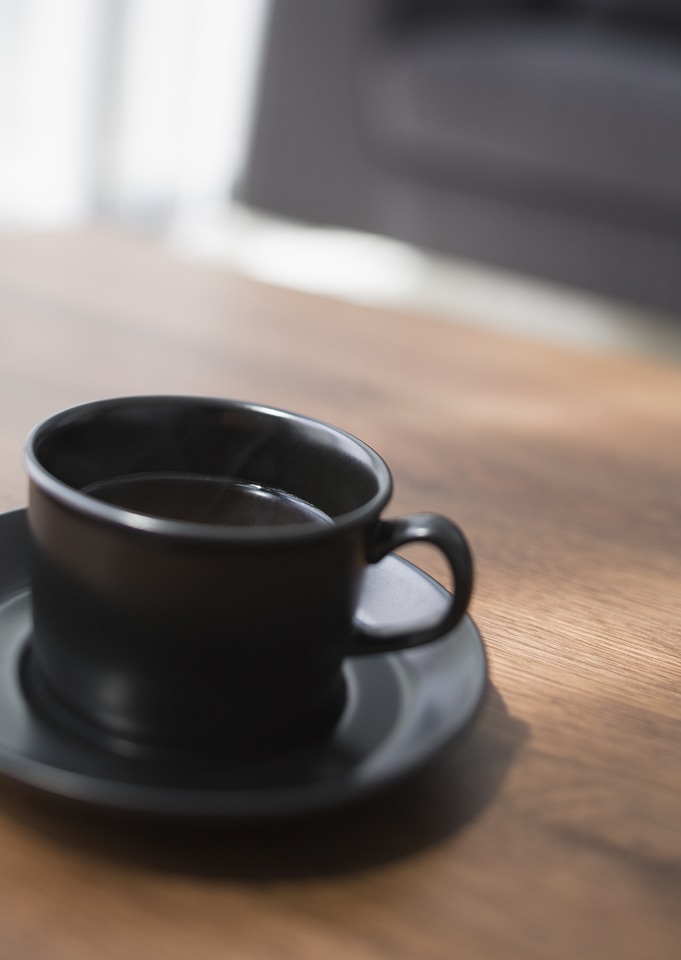 Cup of coffee on table in living room