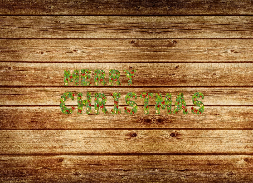 Letters of the christmas made of branches of a pine wooden