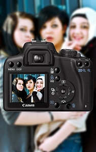 A macro shot of viewfinder of camera, focusing at three woman photo