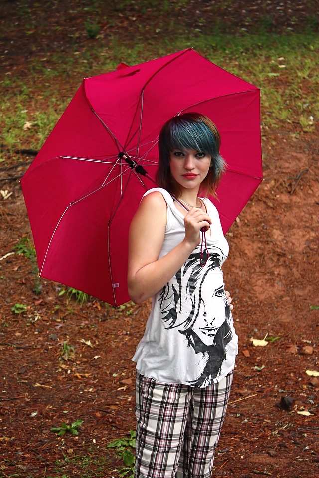 A Beautiful Young Woman Posing With An Umbrella photo