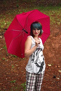 A Beautiful Young Woman Posing With An Umbrella photo