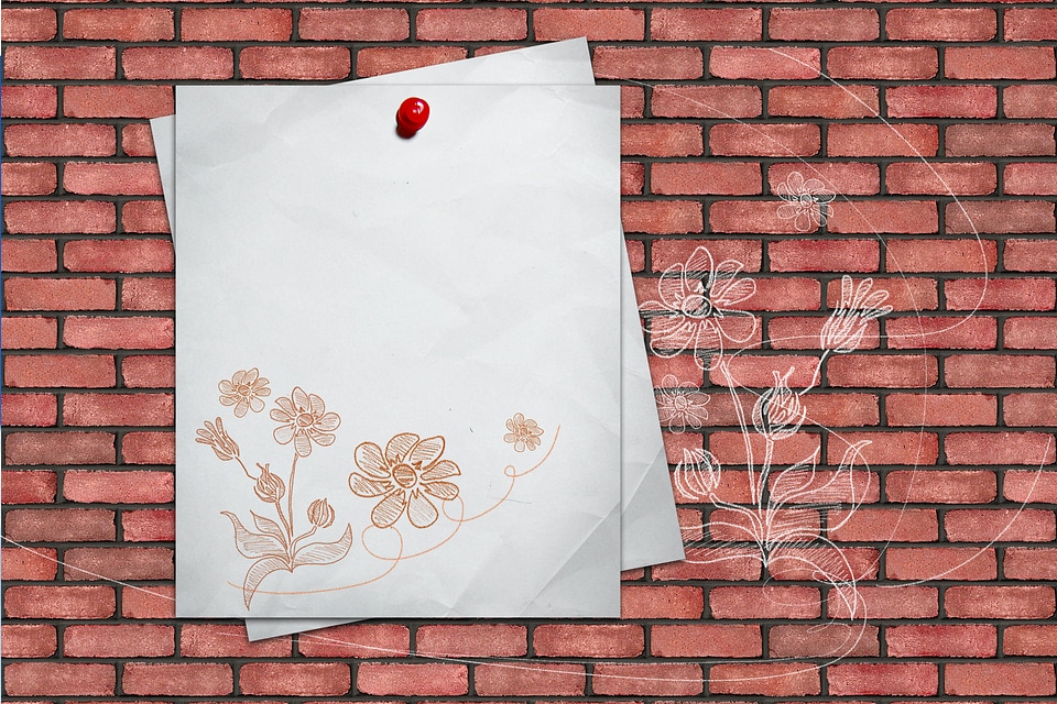 Blank notepaper on brick wall