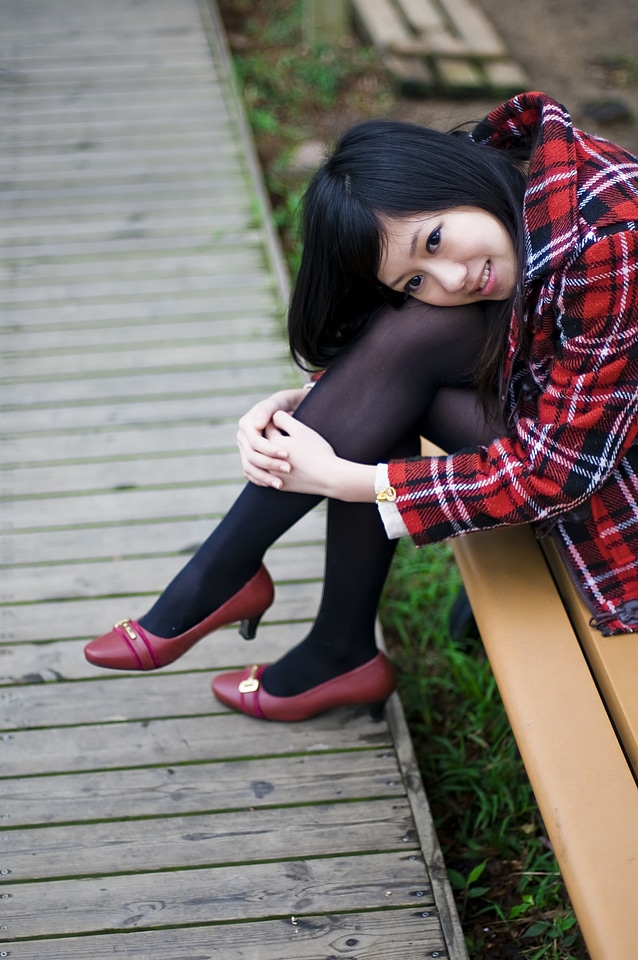 Japanese Girl Posing On A Bench