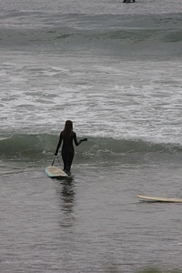 Lone Surfer carrying board along rugged Northern Oregon Coast photo