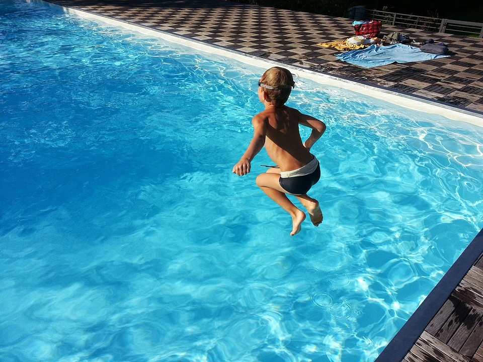 Close up of young boy swimming in pool. photo