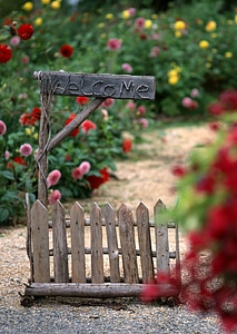 Rusty welcome sign made of wood photo