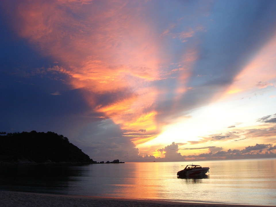 skyline power boat and sunrise silhouette