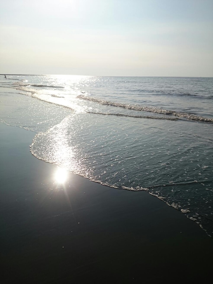 Sandy beach and sun in blue sky