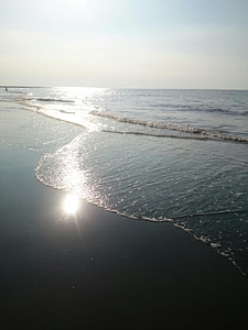 Sandy beach and sun in blue sky