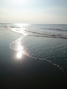 Sandy beach and sun in blue sky photo