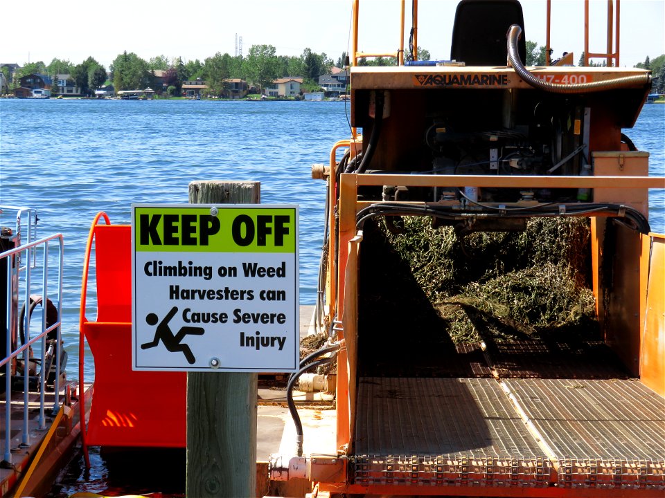 Lake weed harvester at Chestermere Lake
