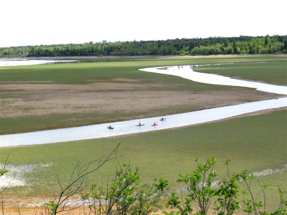 Paddling a channel in the very low Glenmore Reservoir