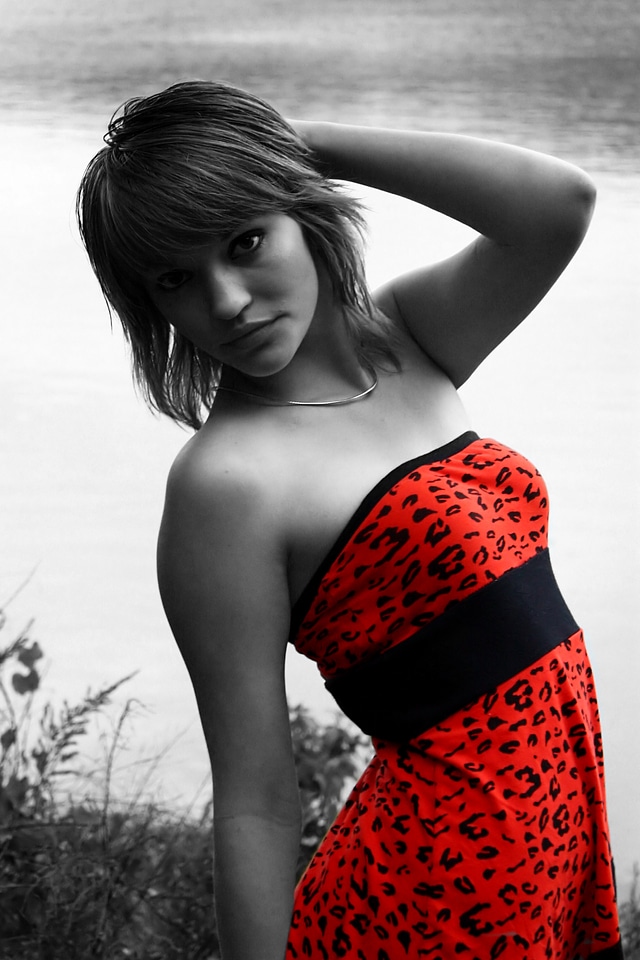 Young Korean Woman Posing In A Red Dress By A Lake