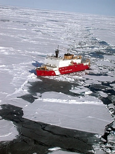 Icebreaker ship on the ice in the sea.