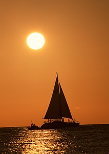 Silhouette of a banca boat against a red sky