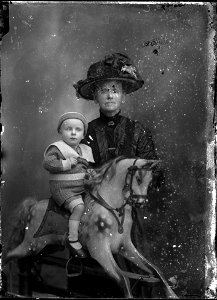 Mrs Jennings with child on rocking horse, [n.d.]