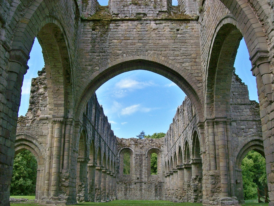 Indoor view of old roofless abandoned cathedral in San Galgano