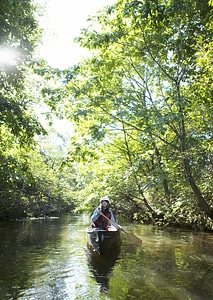 woman with kayak on forest river photo