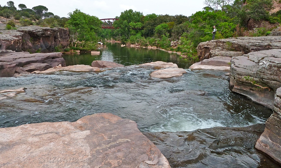 Fisherman with fly fishing on mountain river