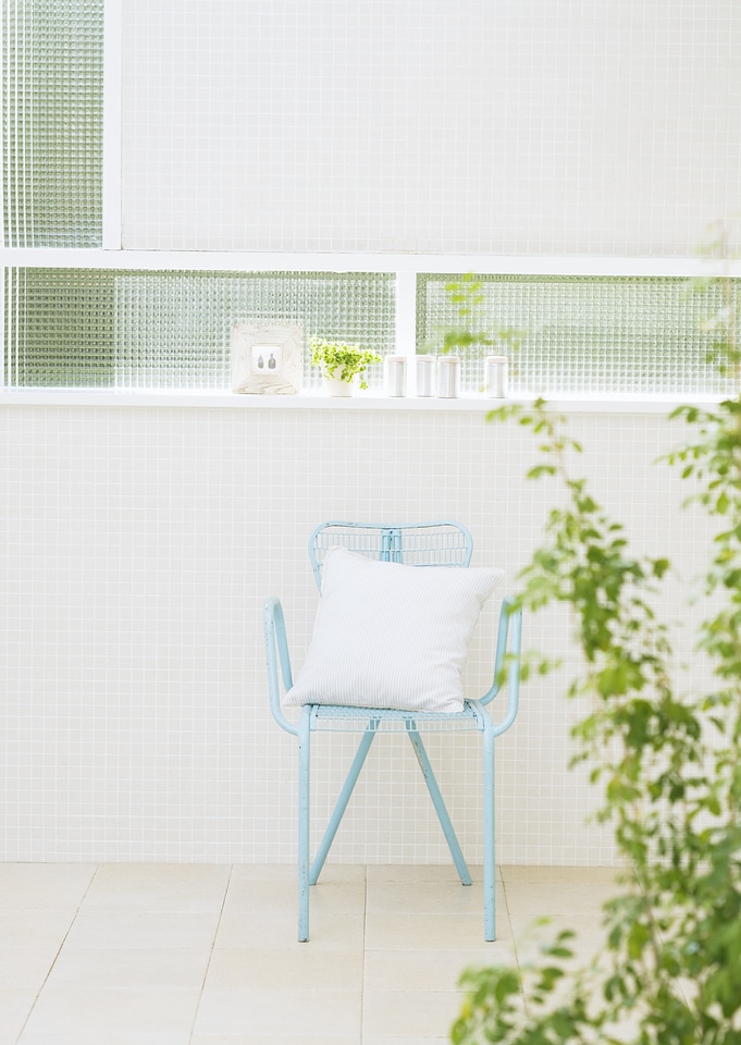 Modern interior with chair and plant.